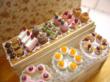 Dollhouse miniature 1/12 scale display shelf with elegant artisan cakes. Entirely handcrafted, this measures 6.5cm by 5.3cm.